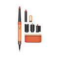 An orange and black hair styling tool shown with multiple interchangeable attachments and a small blue Bluetooth icon on a plain white background.