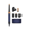 A hair styling tool set on a white background, featuring a navy blue and copper curling iron, several black attachment heads, a round storage case, and a blue Bluetooth logo.